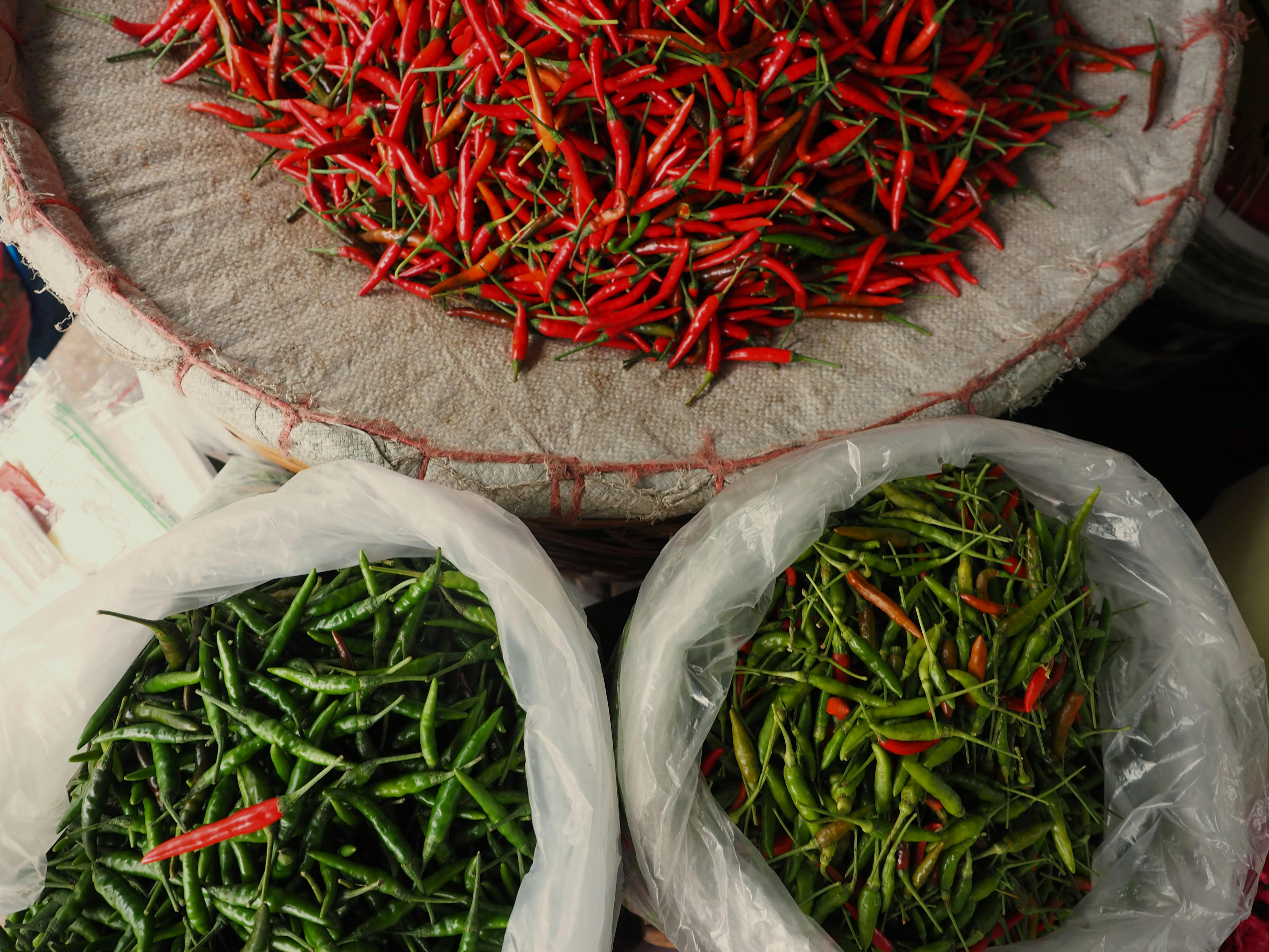 Market baskets of dried red and fresh green chilies